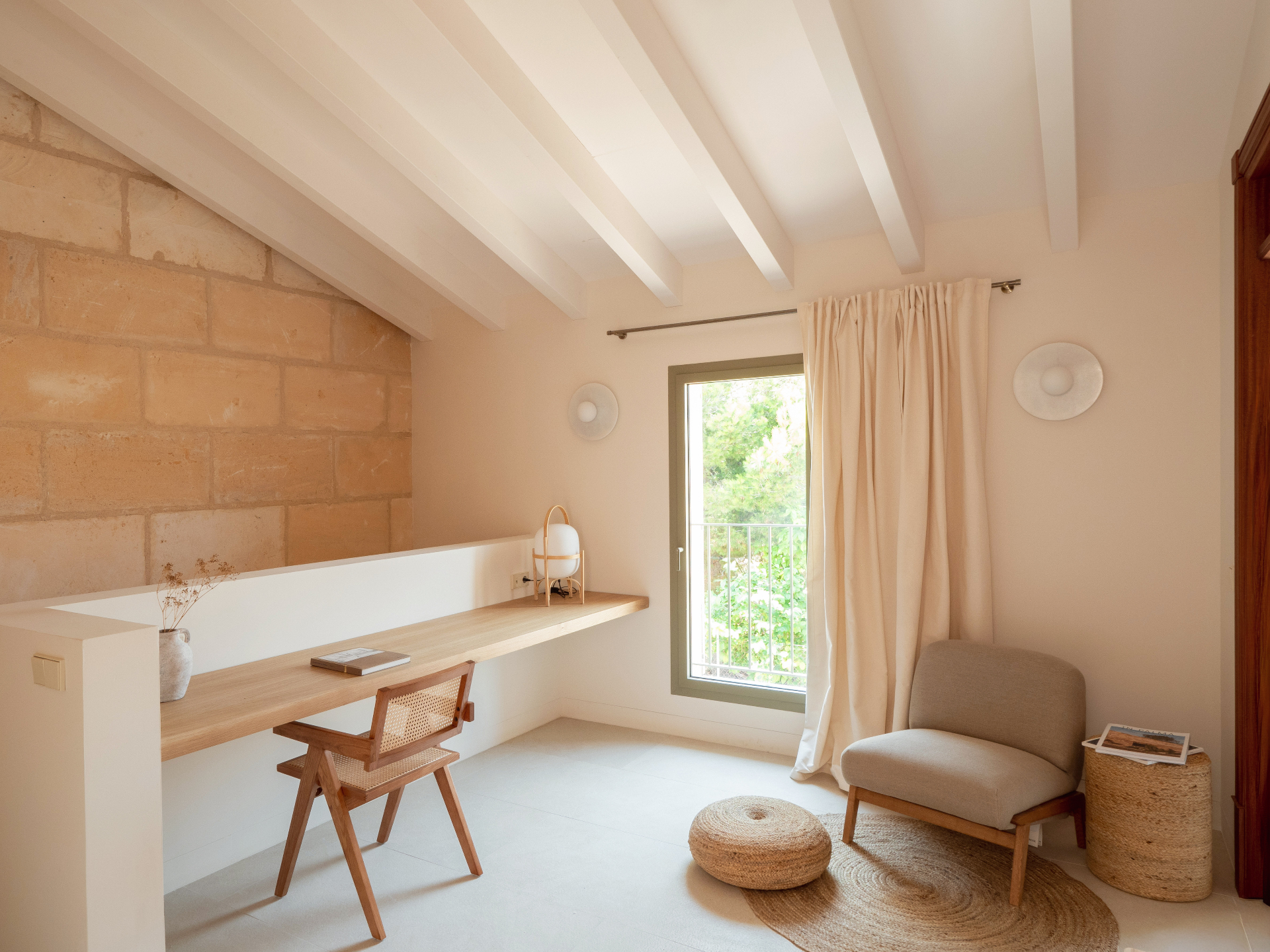 Minimalist studio with wooden desk and two chairs
