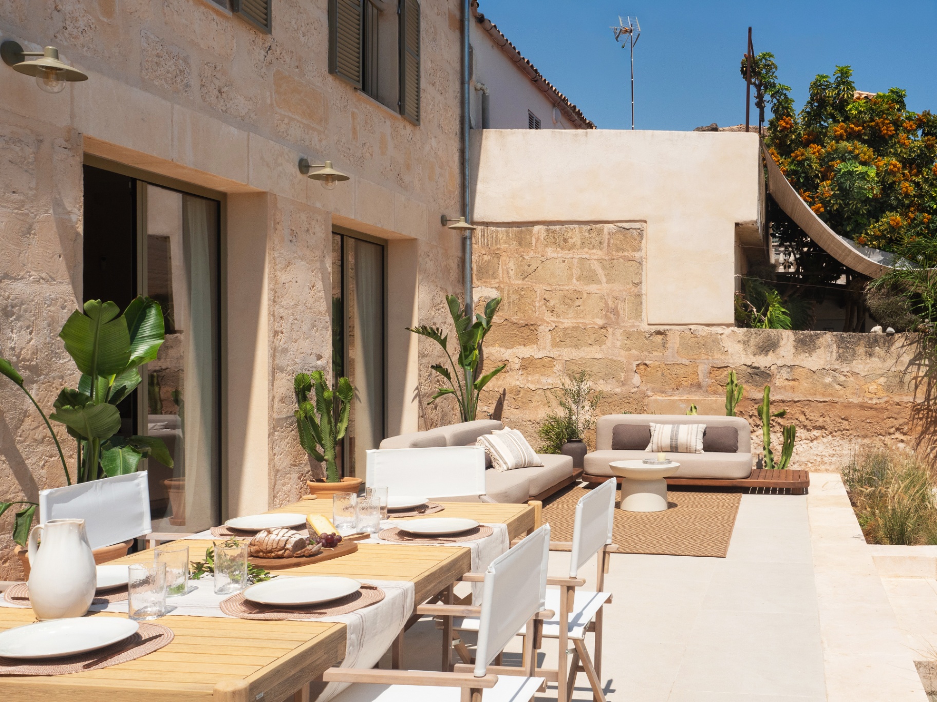 Sunlit stone patio with outdoor furniture