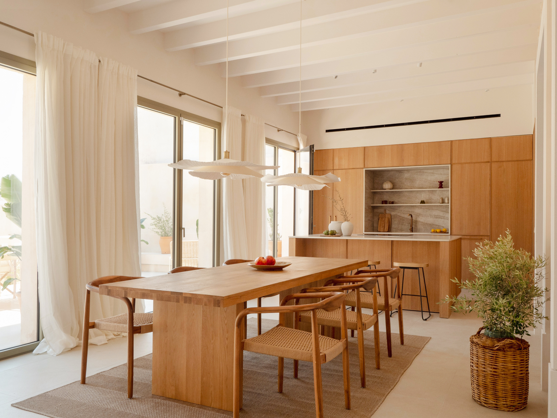 Dining room with long oak table and stone walls